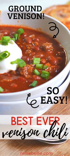 a white bowl filled with chili and sour cream