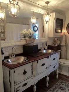 a bathroom with two sinks and a toilet