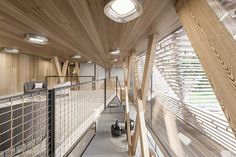 the inside of an office building with wooden walls and ceilinging, along with metal railings