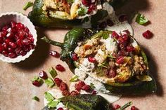 stuffed pomegranates and other food items are arranged on a table top