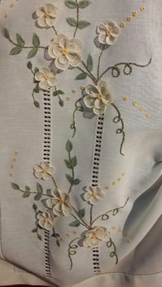 embroidered flowers and leaves on white fabric