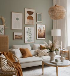 a living room filled with lots of furniture and pictures on the wall above it's coffee table