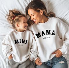 These Personalized MAMA and MINI Sweatshirts are super soft and the perfect gift! These MATCHING Mama and Mini Sweaters are the perfect addition to your wardrobe! These adorable sweaters make the perfect for gift any Mom including new Moms or Moms to be with their individual EST. date. This sweatshirt strikes a perfect balance between style, comfort, and durability. Mama and Mini Sweatshirt, Mommy and Me Outfits, Custom Mommy Sweatshirt, Mama Mini Sweatshirt, Mom Daughter Sweater, Mama and Mini Sweater ♥ PRODUCTION TIME: 1-5 days (Usually 2-3 days) ♥ SHIPPING TIME: 2-5 days (Usually 3 days) ♥ PRODUCT DESCRIPTION: Gildan Crewneck Unisex Sweatshirt (ADULT & YOUTH) Made with a medium-heavy fabric blend of 50% cotton and 50% polyester (8.0 oz/yd² (271.25 g/m this sweatshirt feels cozy and is t Mama And Mini Sweatshirts, Disney Crewneck Sweatshirt, Cute Winter Fits, Mommy And Me Matching Outfits, Matching Sweatsuit, Moms To Be, Mom Daughter Outfits, Outfits Matching, Mini Outfit