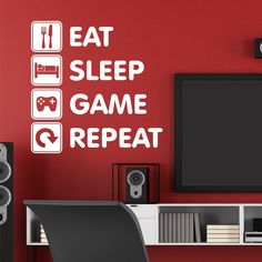 a wall decal with the words eat sleep game repeat on it in front of a computer desk