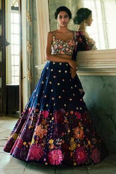 Navy blue lehenga highlighted with heavy multicolored floral embroidery. Comes with chanderi corset blouse and organza dupatta. 
Component: 3
Embroidered
Neckline: Sweetheart
Sleeve Length: Sleeveless
Fabric: Organza, Chanderi
Color: Blue
Embroidered blouse and mirror embellished dupatta
Slits at the hem
Closure:
Blouse: Hooks at the back - Aza Fashions Navy Blue Lehenga, Bridal Lehenga Designs, Blue Organza, Corset Blouse, Geometric Fashion, Blue Lehenga, Indian Look, Salwar Kamiz, Embroidered Lehenga