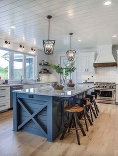 a large kitchen with an island in the middle