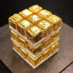 three stacks of gold cubes stacked on top of each other