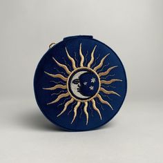 a blue purse with a sun and moon on it