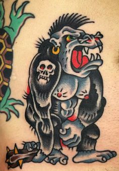 an image of a tattoo on the back of a man's stomach with two monkeys