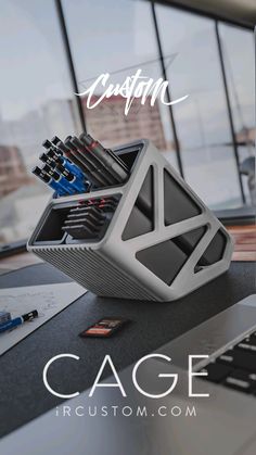 a laptop computer sitting on top of a desk next to a pile of pens and pencils