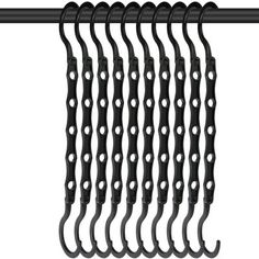 black hooks hanging on a rail with white dots