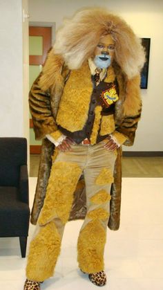 the man is dressed up as a lion in his costume for halloween party or cosplay