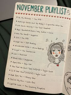 an open notebook with the words november playlist written on it and a drawing of a woman's face