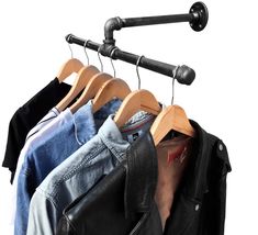 clothes hanging on wooden hangers in front of a white background and black leather jacket