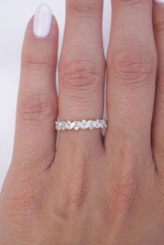 a woman's hand with a wedding ring on it