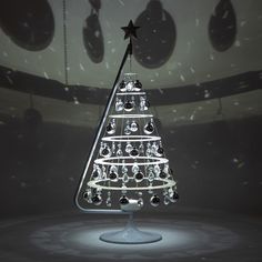 a lighted christmas tree on display in a dark room