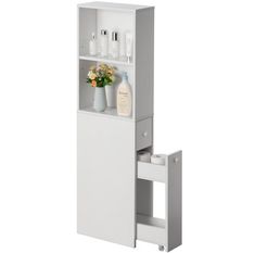 a white cabinet with flowers and bottles on it