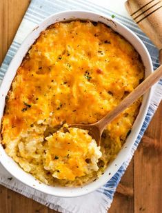 a casserole dish with mashed potatoes and parmesan cheese