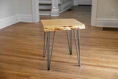 a small wooden table sitting on top of a hard wood floor