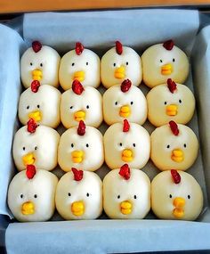 twelve rubber ducks in a box with red bows on their heads and yellow beaks