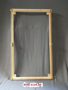 an old wooden frame with roped edges on a white sheeted background, ready to be used as a wall hanging