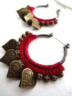 two pairs of red and gold bracelets with heart shaped charms on each one side