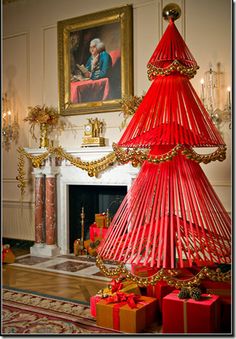 a red christmas tree in the middle of a room