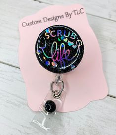 Show off your ID badge with badge reels made just for you by Custom Designs By TLC. The badge reels are made with acrylic and UV Resin. This badge reel can be customized with your color choices or as is.  **With all of my badge reels you will have the option to purchase it with or without a matching badge buddy Keep in mind when choosing colors, that dark colors don't go well with dark colors and the same goes for light colors. You want contrasting colors. Please feel free to message me if you have an questions regarding color choices prior to ordering as I am not responsible if colors chosen are not easy to read.  Don't see a design you want? Message me and we can try and create a design that works for you.  *We also do bulk orders, please message me for details. *This listing includes 1 Personalized Black Badge Reel For Personal Use, Black Badge Reel With Swivel Clip As A Gift, Nurse Scrubs, Badge Buddy, Scrub Life, Custom Badges, Rubber Gloves, Retractable Badge Reel, Uv Resin