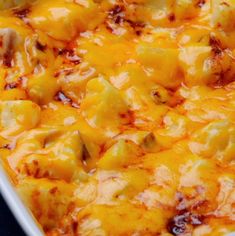 a casserole dish with potatoes and cheese in it