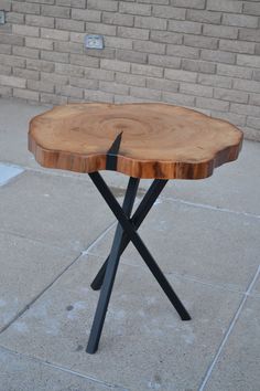 a wooden table sitting on top of a sidewalk