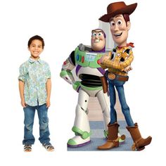 two children standing next to toy story characters