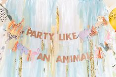 party like an animal banner with balloons and streamers