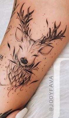 a deer with antlers on it's head is shown in this tattoo design