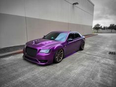 a purple car is parked on the street