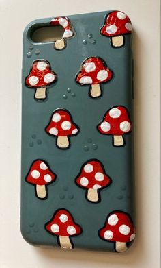 a phone case with mushrooms painted on it