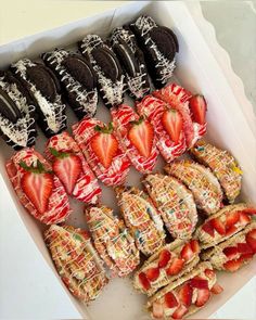 a box filled with lots of different types of cookies and strawberries on top of each other