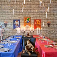 the table is set with plates, silverware and knight figurines on it