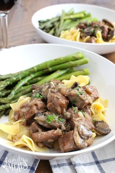 an easy beef and pasta dish with asparagus on the side in a white bowl