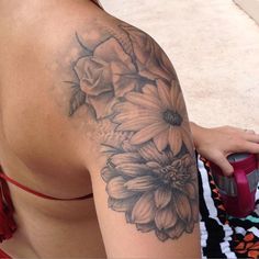 a woman's arm with flowers on it