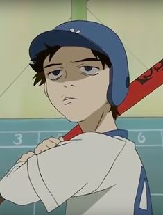 a young baseball player holding a bat in his right hand and wearing a helmet on top of his head