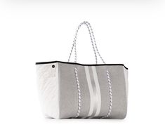 The original neoprene tote bag with a versatile design for work, travel, gym or a diaper bag Heather marle with white/silver/white stripe. White quilted reflective sides with side exterior slip pockets. Side panels include snap closure for streamline look. Includes wristlet pouch. 8.5" × 6" Bag dimensions - 18" × 12" × 10" prefect everyday bag for work, gym or traveling vacation ready bag Bottom Liner, Neoprene Bag, Tennis Bag, Wristlet Pouch, Neoprene Tote, Everyday Tote, White Quilt, Heather White, Mix Media