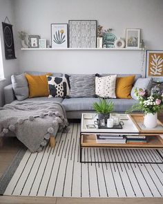 a living room filled with lots of furniture and pictures on the wall above it's coffee table