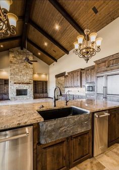 a large kitchen with granite counter tops and wooden cabinets, along with an island in the middle