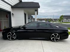 a black car parked in front of a house