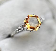 Stunning hexagon citrine ring with side moissanites. This item can be designed with other gemstones per request. Sterling silver/vermeil option comes with side moissanites, solid gold option comes with side diamonds. Item details: main stone - citrine hexagon 7mm side stones: moissanite or white diamonds F - G, VS metal: sterling silver,14k 18k rose/white/yellow, platinum Band width: 1.8mm Package will be shipped in gift packaging with DHL express, insured. signature is required. ★ ★ ★ ★ ★ ★ ★ ★ Octagon Shaped Sterling Silver Topaz Ring, Faceted Topaz Wedding Rings, Emerald Cut Yellow Topaz Ring For Wedding, Modern Citrine Wedding Jewelry, Modern Citrine Jewelry For Wedding, Elegant Octagon Citrine Rings, White Gold Citrine Rings With Diamond Cut, Octagon-shaped Citrine Jewelry For Anniversary, Octagon Shaped Citrine Jewelry For Anniversary