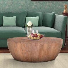 a living room with a green couch and coffee table