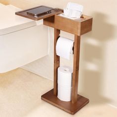 a phone is sitting on top of a wooden stand with toilet paper in front of it