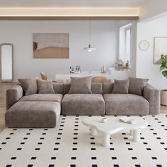 a living room filled with furniture and a white coffee table on top of a black and white checkered rug