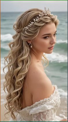 a woman with long blonde hair and a tiara on her head standing in front of the ocean