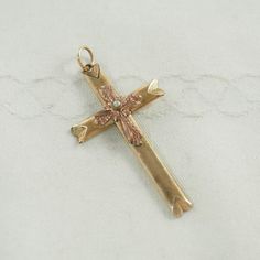 A charming antique Victorian foam gold cross pendant in yellow gold tone.  The Roman or Latin cross with mitered points, the center with a smaller gothic style cross in rose gold tone with a central faux seed pearl, 1mm in diameter.  With a circular bail.  Unmarked. The chain is for display only. Germany or Bohemia circa 1890-190 2.1g Cross 4.5cm x 2.5cm   In inches  1 3/4" x 1". With bail 5cm.  In inches 2". The gilding fresh and bright in bi-color gold tones. Tiny amounts of wear at the edges, Antique Brass Cross Pendant Jewelry, Victorian Gold Cross Pendant Jewelry, Gold-plated Yellow Gold Crucifix Necklace, Yellow Gold Diamond-cut Crucifix Necklace, Yellow Gold Crucifix Cross Necklace, Gold Plated, Rose Tone, Crosses Decor, Gold Cross Pendant, Small Crosses